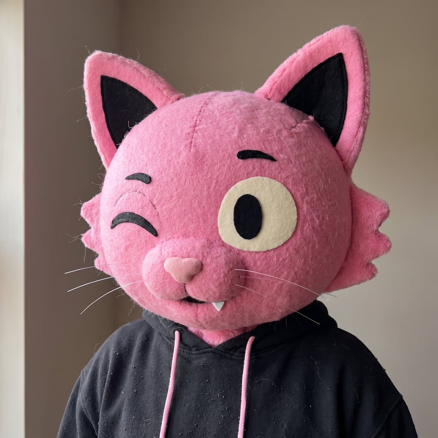 Close-up of the Puss plush mascot head